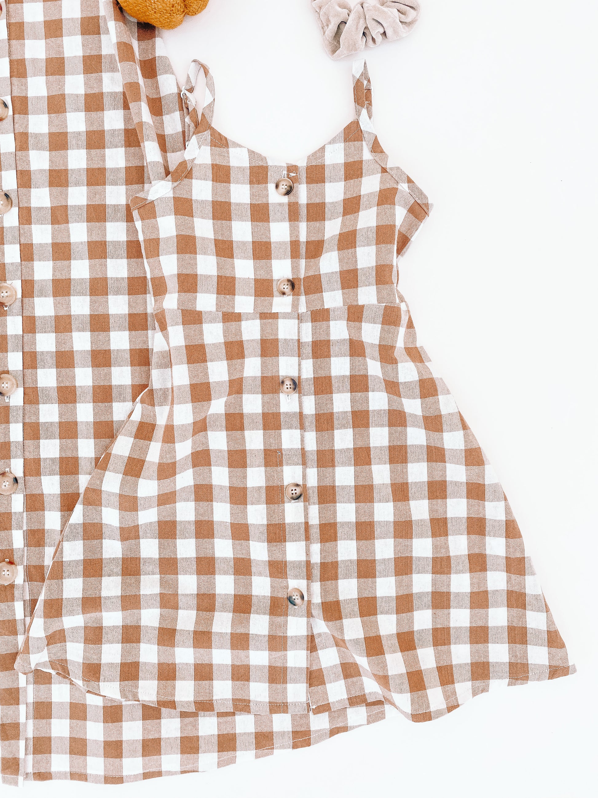 Pattern is a brownish and white checkered pattern. With functional buttons straight in the middle wood like style.