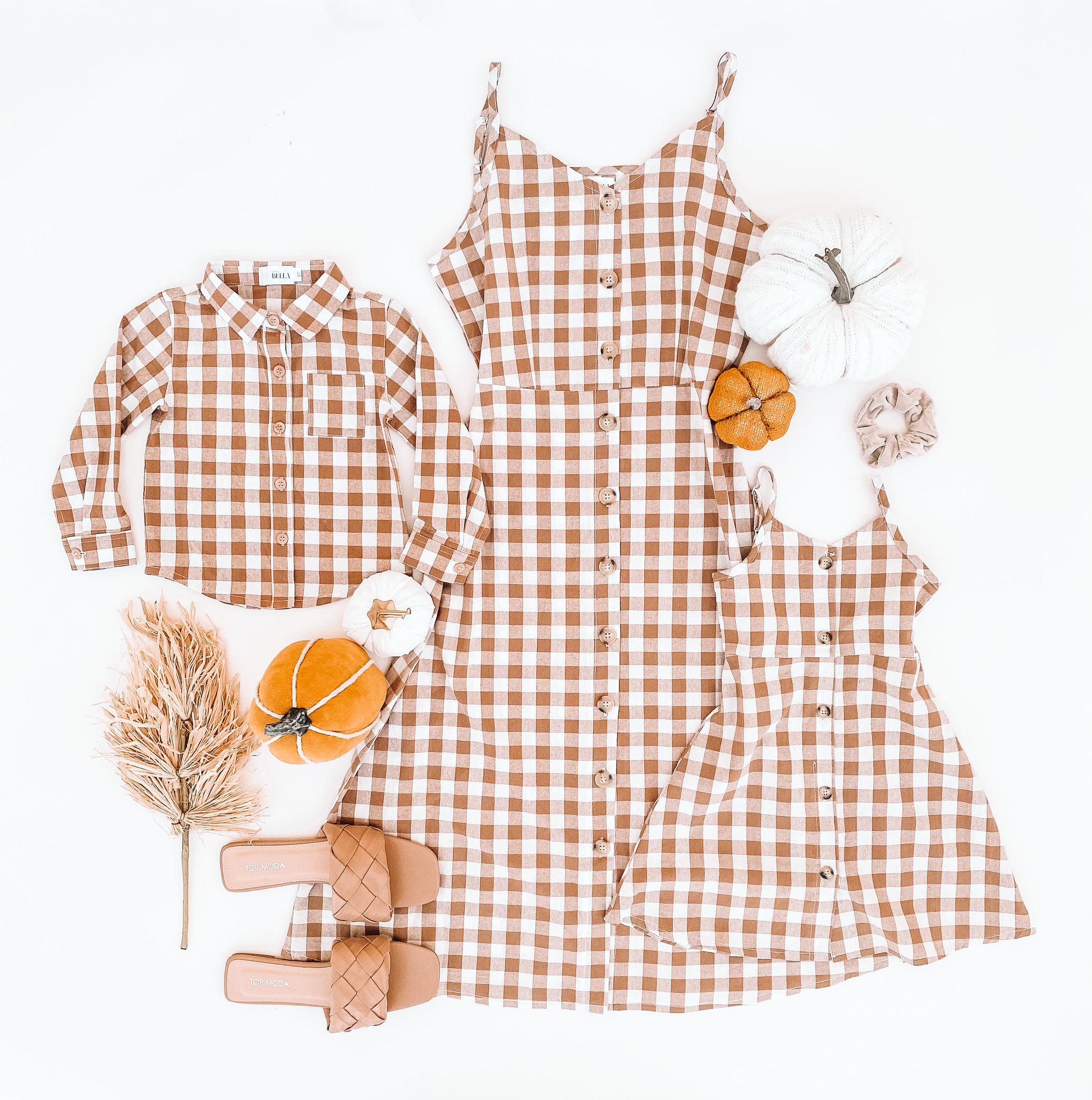 Boy shirt is a long sleeve flannel style with a small pocket on the right- hand side. Adult is a checkered knee length dress same style for girl style. Dresses are thin strap adjustable.