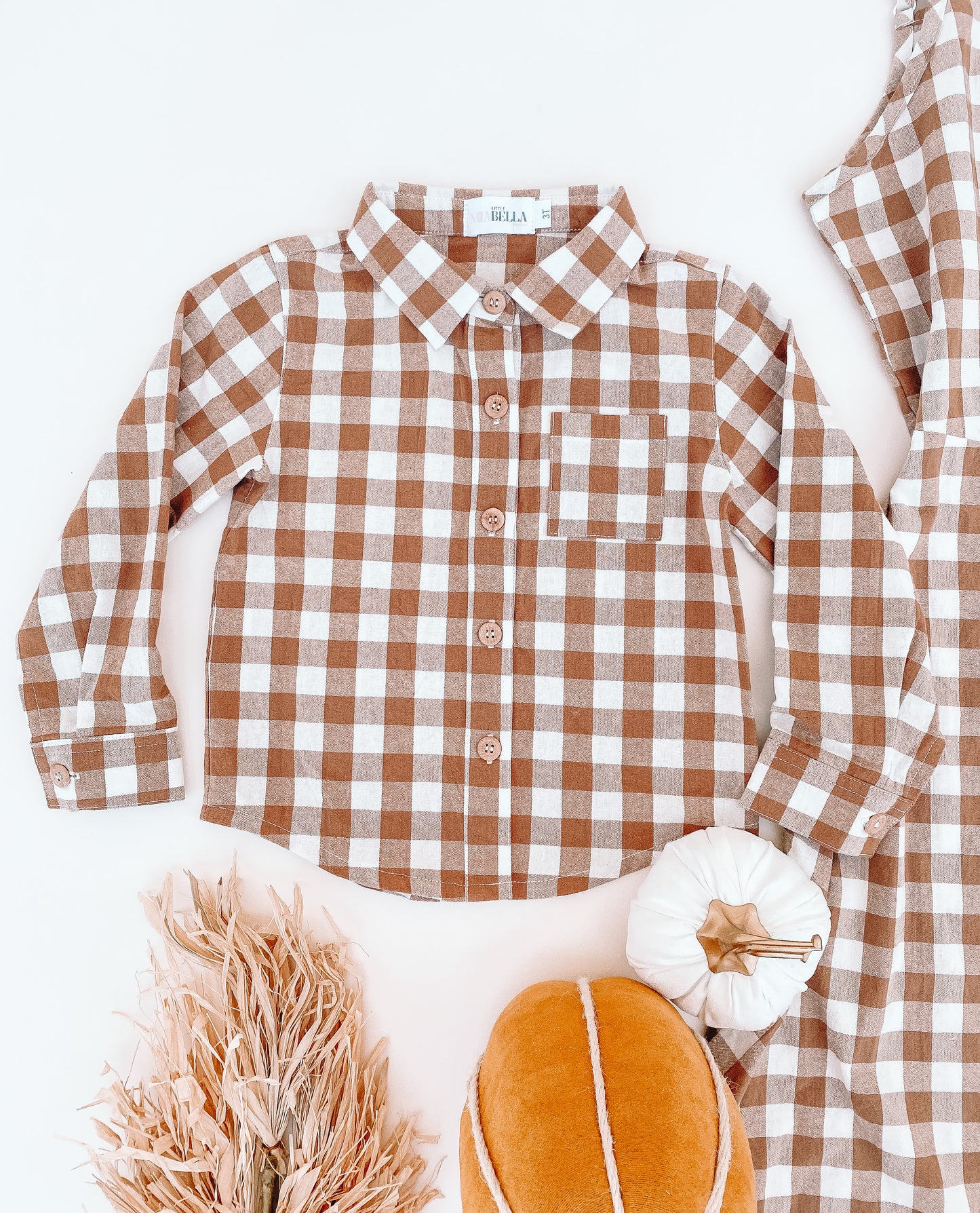 Boy flannel shirt with collar neckline. Pattern is brownish and white checkered style 
